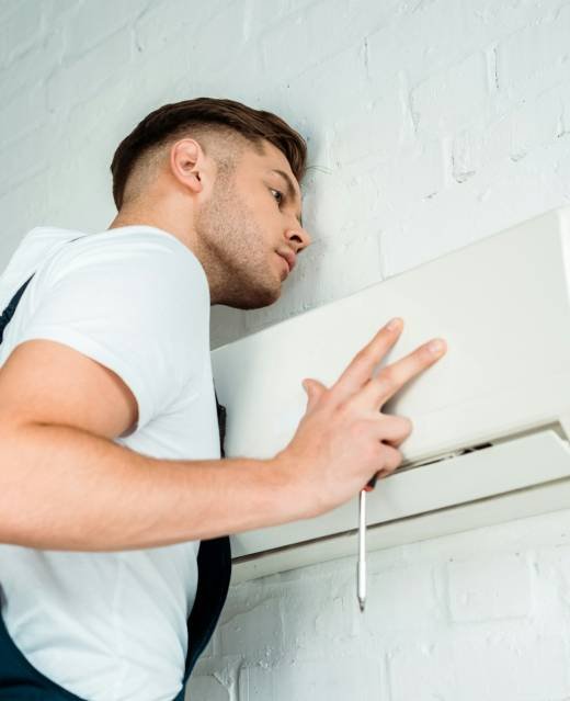handsome worker installing air conditioner handsome worker installing air conditioner
